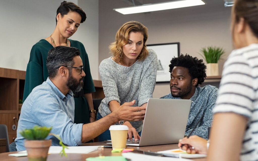 team of men and women looking at computer, discussing preparation for active violence situation